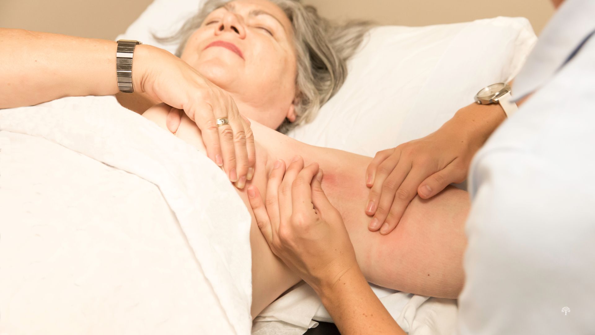 Woman receiving gentle lymphedema therapy on a treatment table at Taylor Physical Therapy & Wellness, showing holistic, hands-on care to reduce swelling and restore comfort after breast cancer treatment.