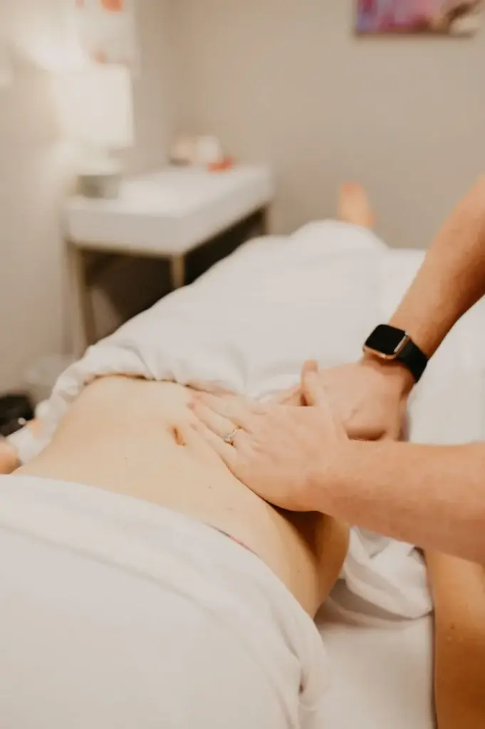 Pelvic health therapist providing abdominal manual therapy