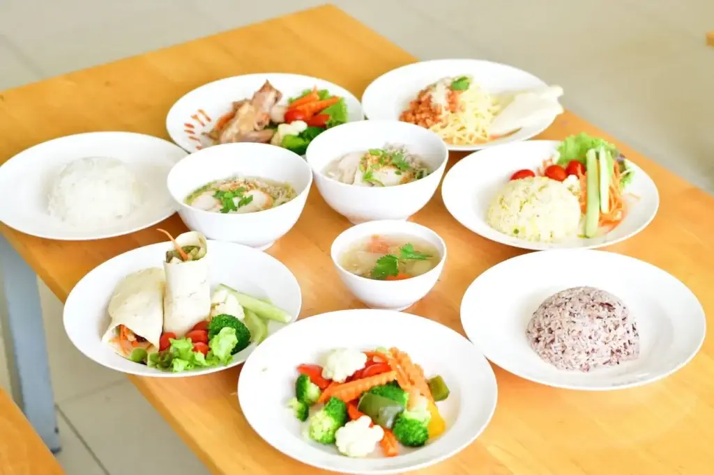 Several plates of healthy meals on a table