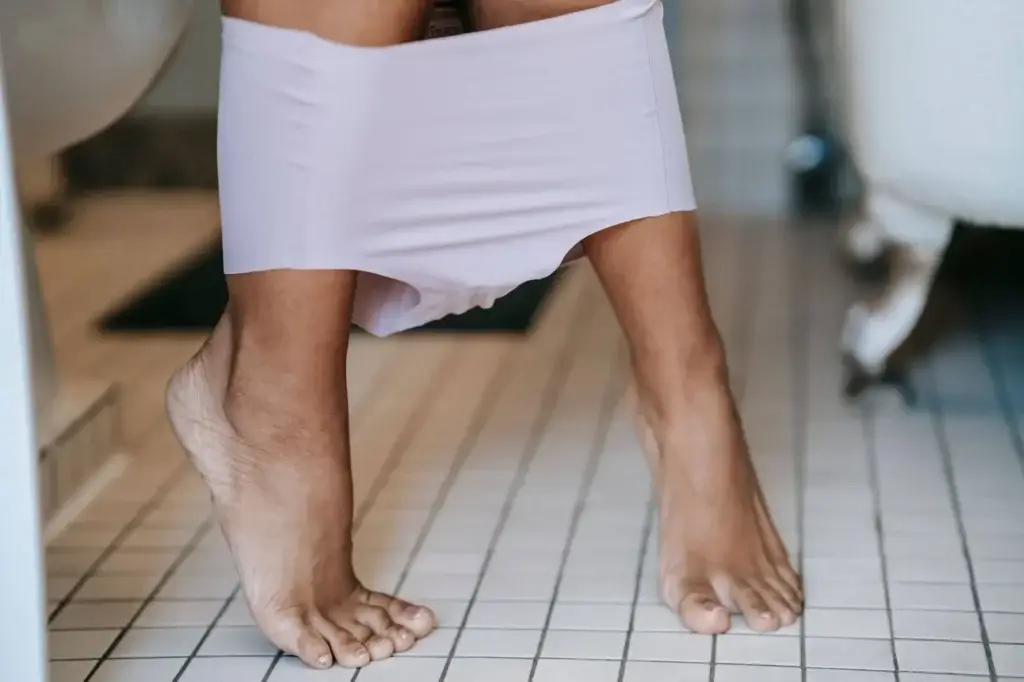 A woman uses the restroom in her home