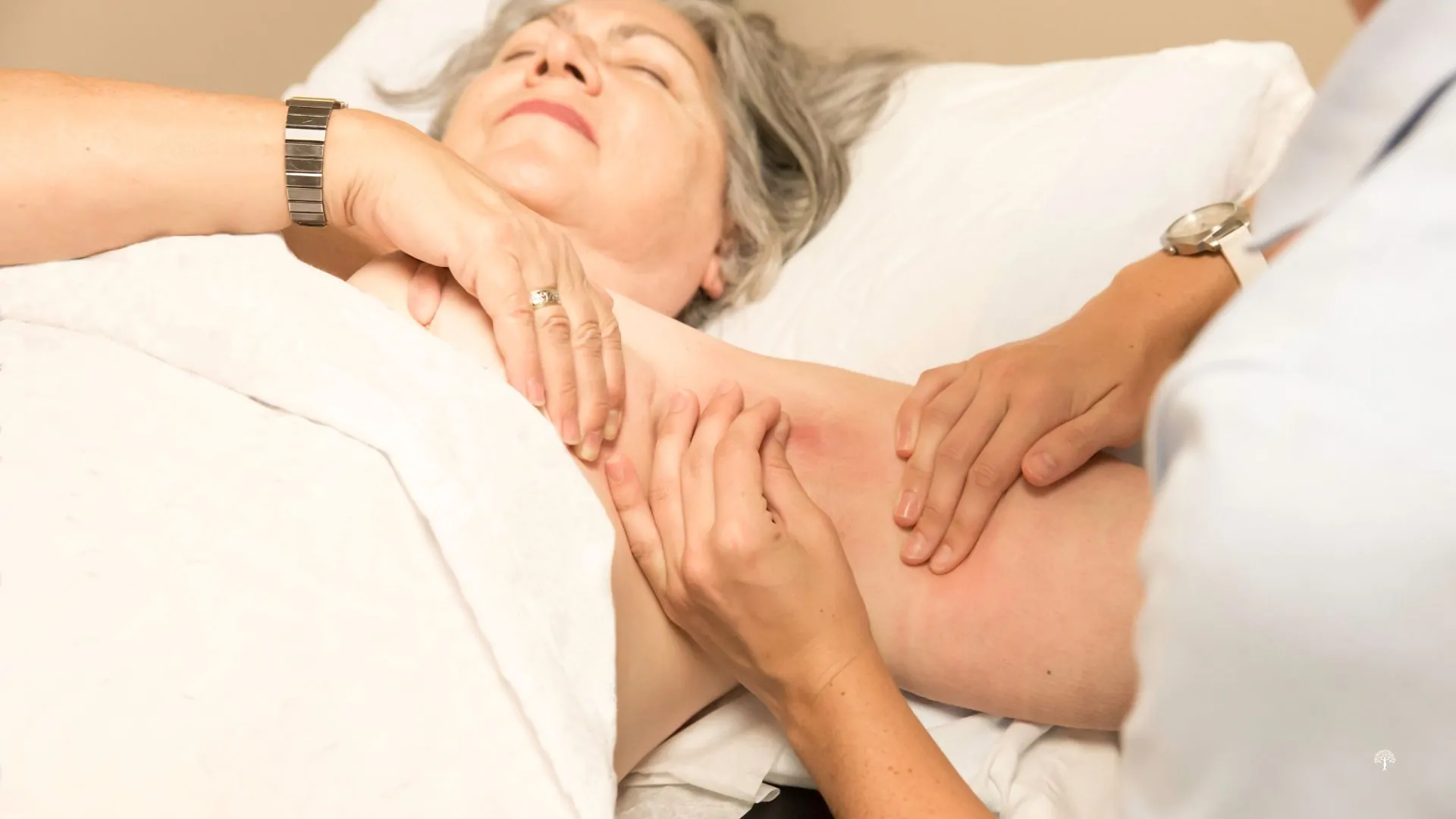 Woman receiving gentle lymphedema therapy on a treatment table at Taylor Physical Therapy & Wellness, showing holistic, hands-on care to reduce swelling and restore comfort after breast cancer treatment.